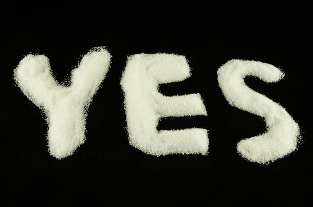 istock YES from sugar on black background , word 1206682168