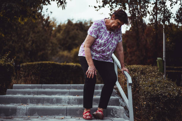 istock Weak senior woman about to fall on the stairs outside 1206682449