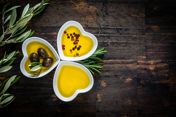 istock Three heart shaped bowls filled with olive oil. Copy space. 1206682739