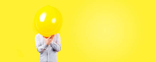 istock man holding yellow balloon 1206685307