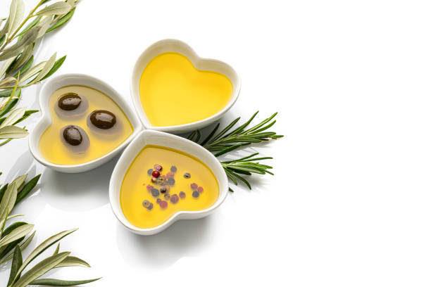 istock Three heart shaped bowls filled with olive oil on white background. Copy space. 1206685535