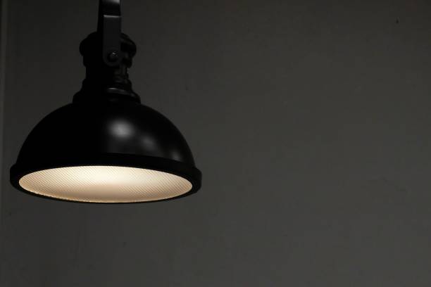 istock A modern lamp hanging from the room ceiling and glowing in the dark night 1206689505