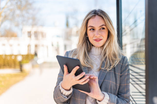 istock Young woman using a digital tablet outdoors stock photo 1206692998