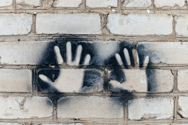 istock Imprint of two hands on a brick wall. 1206693931