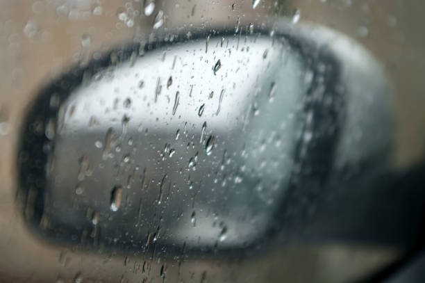 istock Raindrops on the car rearview mirror. Selective focus. Toned. 1206694236