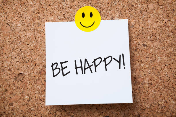 White Sticky Note With Be Happy And Red Push Pin On Cork Board