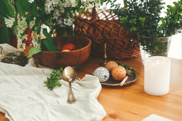 istock Stylish Easter eggs with modern wax ornaments and natural dyed eggs on rustic wooden table with spring flowers, basket, candle, linen cloth, buxus. Happy Easter. Stylish Rural still life. Zero waste 1206695419
