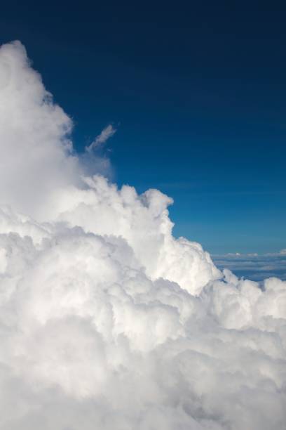 istock Fluffy clouds (Cumulonimbus) at high altitude over deep blue sky. Heaven, freedom, purity concept. 1206695707