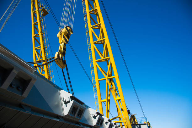 istock Loading in port. Floating port crane on blue sky background 1206696718