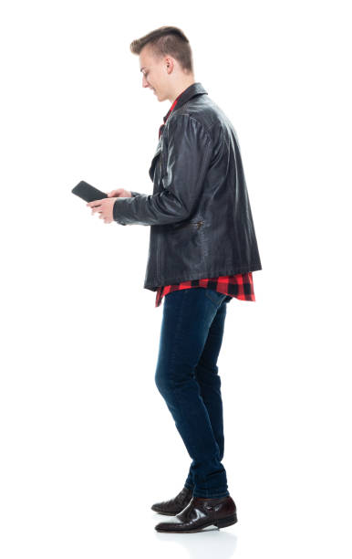 istock Caucasian boys standing wearing t-shirt and using mobile phone 1206697113