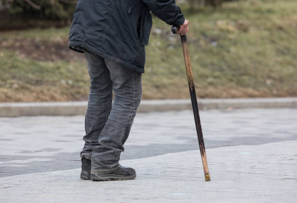 istock disabled person with cane on the street 1206697192