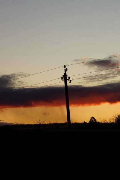 istock Silhouette high voltage electric tower in sunset sky. 1206700556