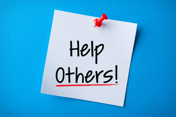 istock White Sticky Note With Help Others And Red Push Pin On Blue Background 1206700713