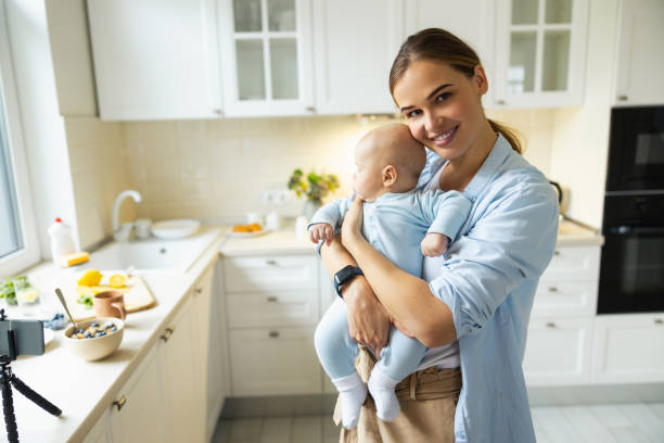 istock Happy young mother playing with her baby in the kitchen 1206701429