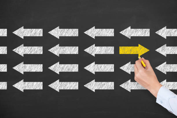 istock Going Your Own Way with Arrows Symbol on Blackboard Background 1206704389