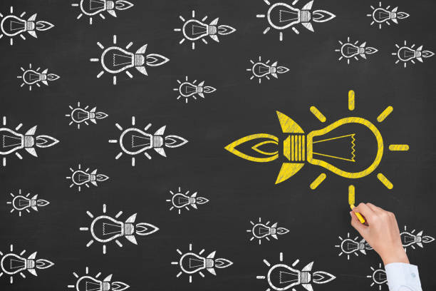 istock Going Your Own Way with Light Bulbs Symbol on Blackboard Background 1206704467