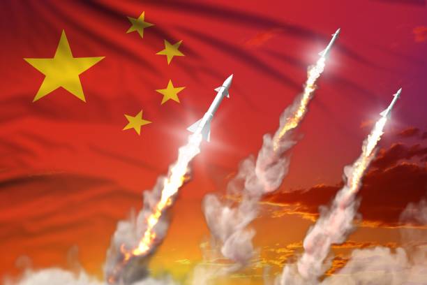 istock China nuclear warhead launch - modern strategic nuclear rocket weapons concept on sunset background, military industrial 3D illustration with flag 1206705113
