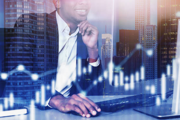 istock Smiling African businessman in office, graph 1206708491