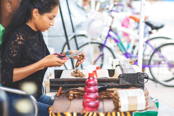 istock Beautiful woman making cigars. 1206708504