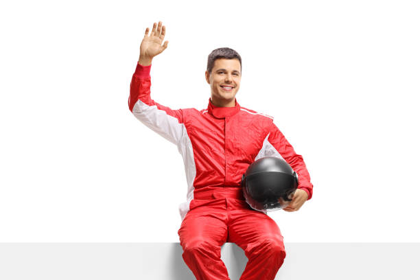 istock Racer sitting on a panel and waving at the camera 1206709561