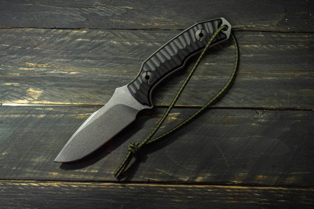 istock Knife on a wooden background. Dim light on the knife. 1206710467