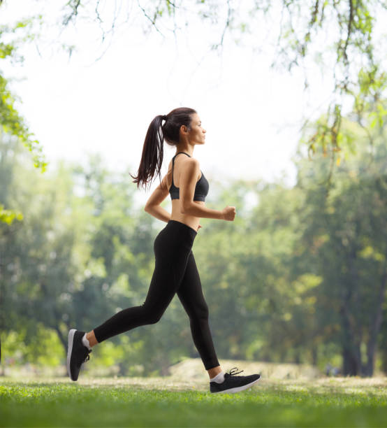 istock Young woman jogging in a park 1206712188