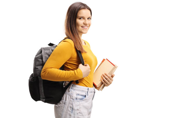 istock Smiling female student carrying a backpack and holding books 1206713347