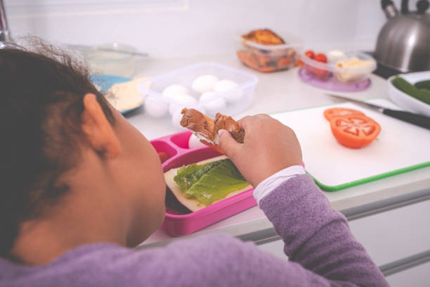 Seamless pattern healthy school lunch with sandwiches, nuts and berries in a plastic container on blue.