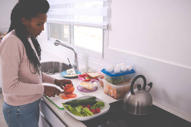 istock Woman preparing kids breakfast / lunch for school. 1206713933
