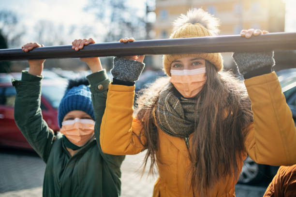 kids wearing anti virus masks playing outside - illness mask pollution car imagens e fotografias de stock