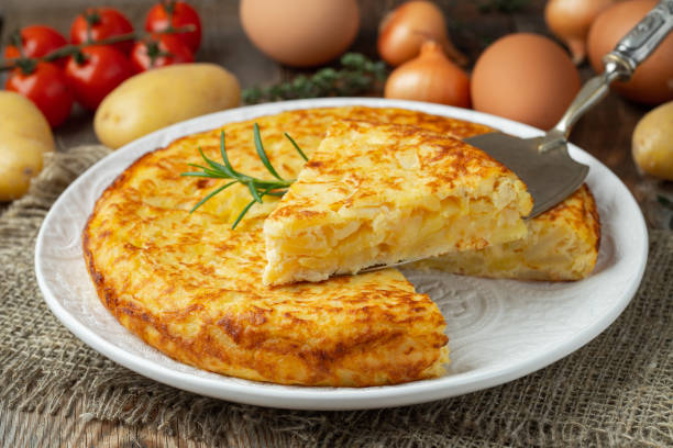 istock Spanish omelette with potatoes and onion, typical Spanish cuisine. Tortilla espanola. Rustic dark background. Top view 1206715849
