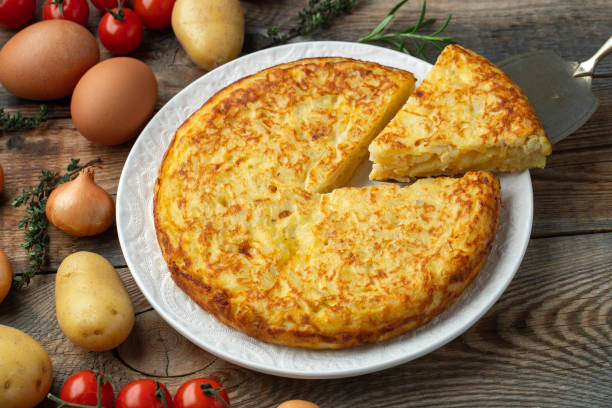 istock Spanish omelette with potatoes and onion, typical Spanish cuisine. Tortilla espanola. Rustic dark background. Top view 1206715851
