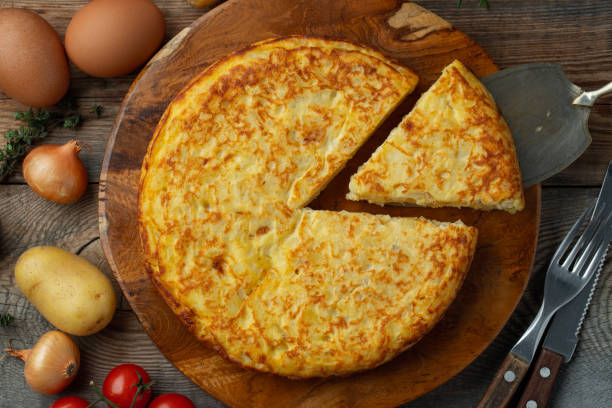 istock Spanish omelette with potatoes and onion, typical Spanish cuisine. Tortilla espanola. Rustic dark background. Top view 1206715872