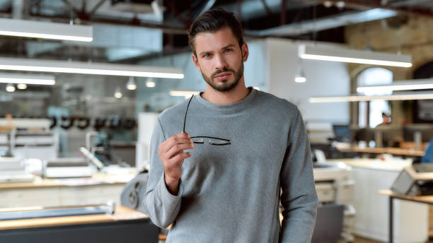 istock A cheerful and active employee is much better. Young businessman posing in office 1206716418