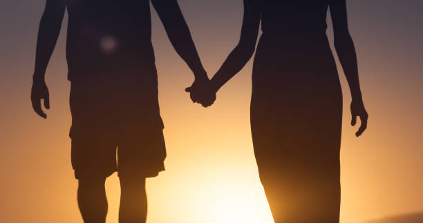 istock Couple holding hands at sunset 1206717110