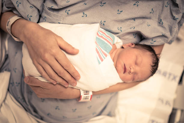 istock Mother and her sleeping newborn baby 1206717131