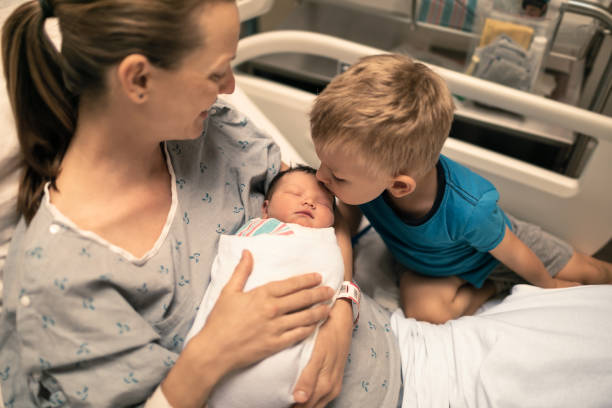 I am a big brother. Family visiting after childbirth. Family visiting after childbirth. childbirth photos stock pictures, royalty-free photos & images