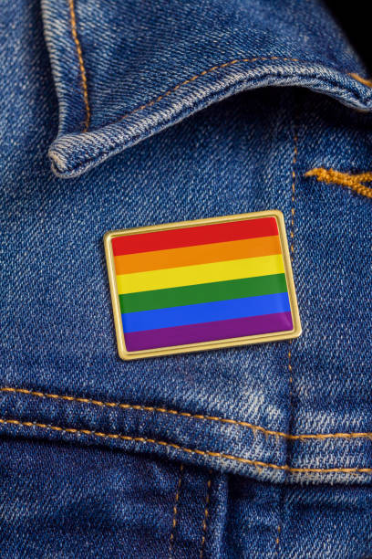 Gay pride flag pin on a denim jacket for LGBTQ identity, pride, and activism. The flag design is public domain for all uses. Gay pride flag pin on a denim jacket for LGBTQ identity, pride, and activism. The flag design is public domain for all uses. public domain photos stock pictures, royalty-free photos & images