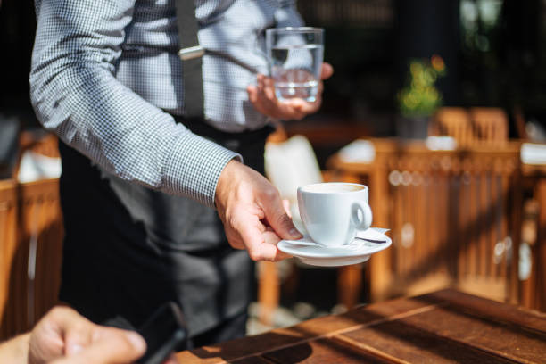 istock Cafe worker bringing an order to his customer 1206718961