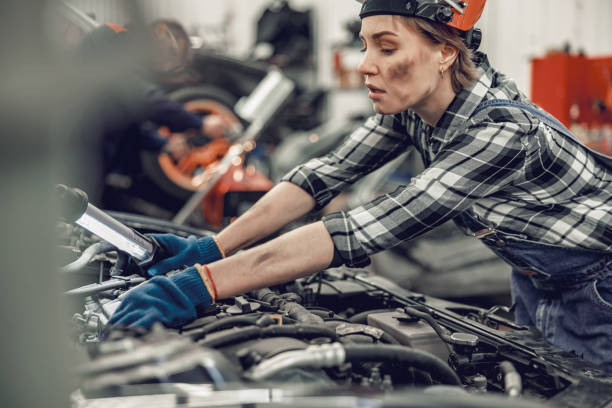 istock Mechanic with a lamp inspecting a vehicle 1206720494