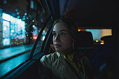 Woman enjoying a taxi ride during night