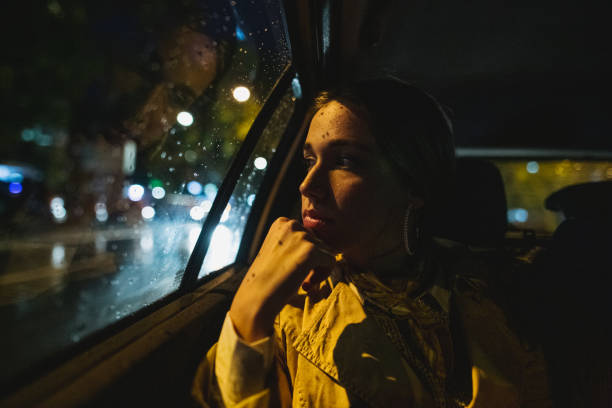 istock Woman lost in thought while riding in a taxi 1206720700