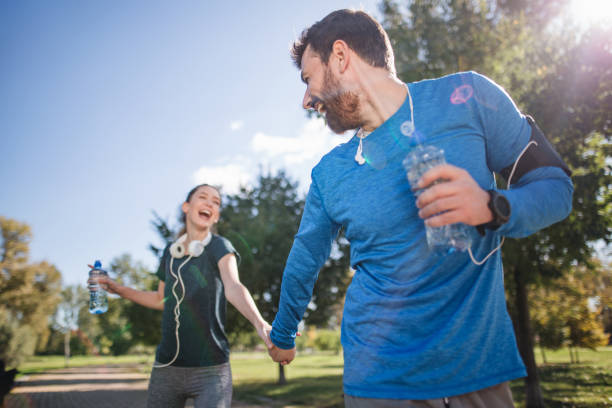 istock Athletic couple in love bonding in a public park 1206720747