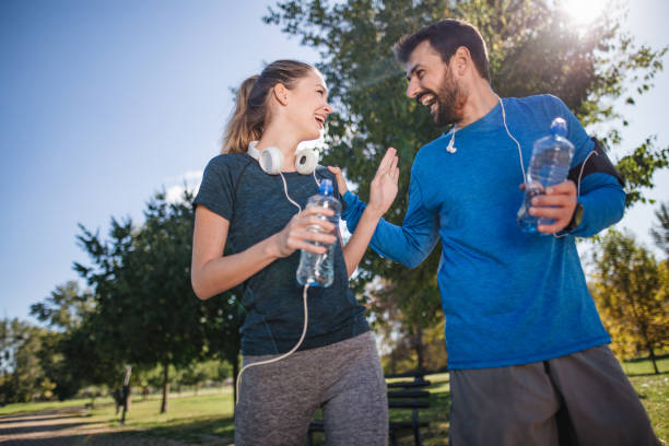istock Happy athletes relaxing in a public park 1206720749