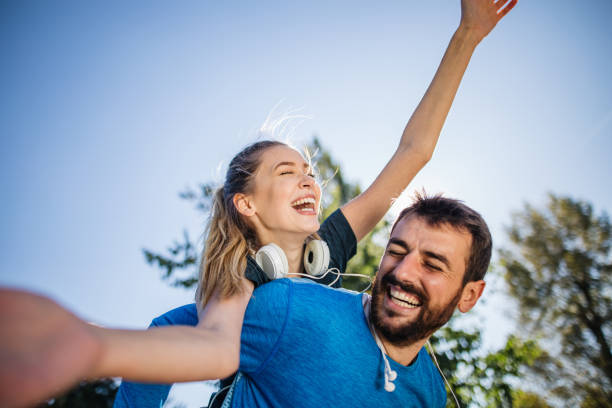 istock Carefree couple playing around in a public park 1206720754