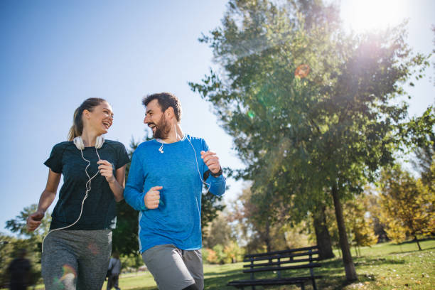 istock Active young people running in a public park 1206720759