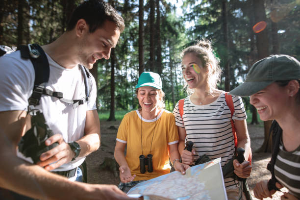 istock Lost group of hikers looking at a map 1206720813