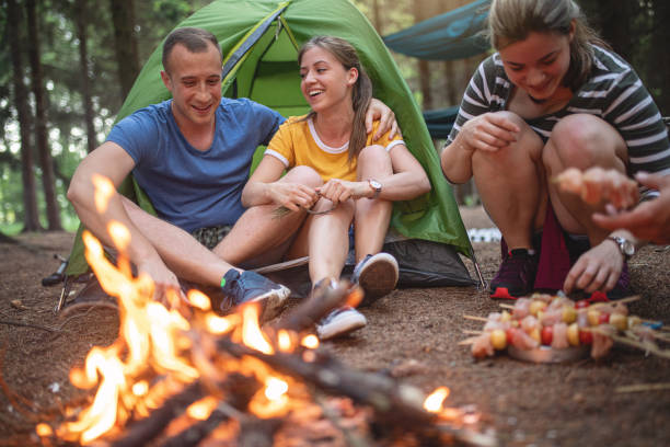 istock Couple bonding near a camp fire 1206720845