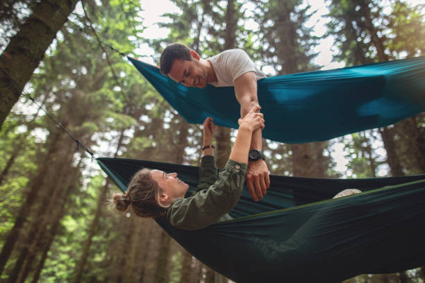 istock Happy young couple bonding while lying in hammocks 1206720853