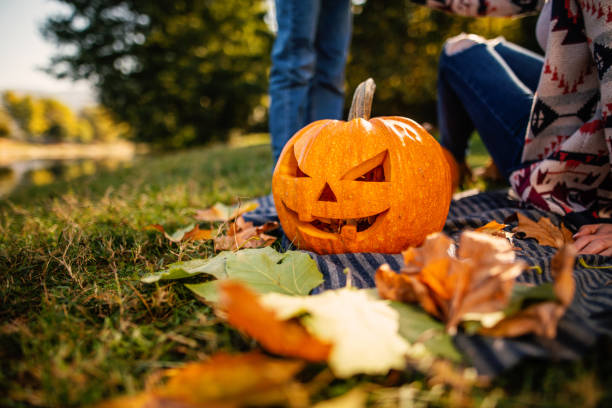 istock Halloween Jack o' Lantern pumpkin in a park 1206721041